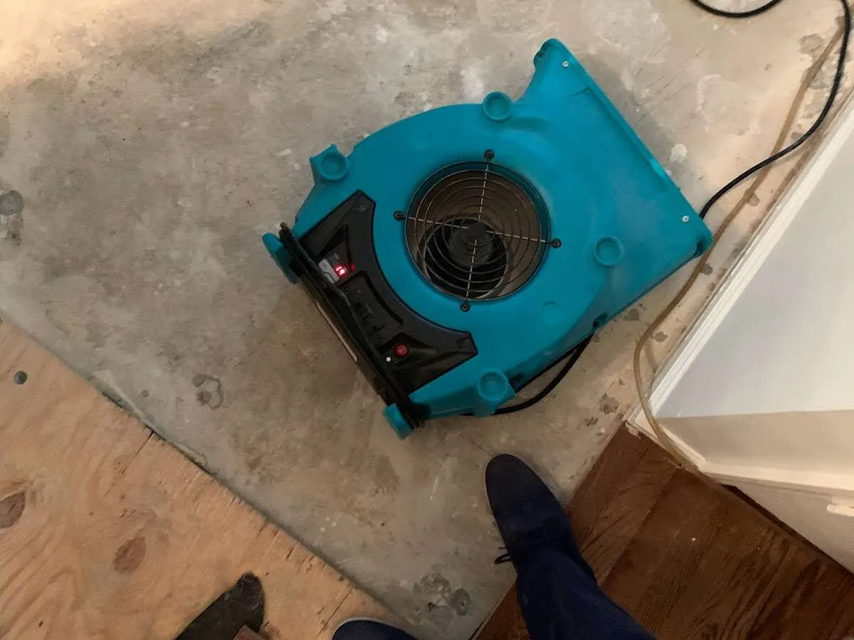 Air mover drying subfloor during Commercial Water Damage Restoration in Highland Village